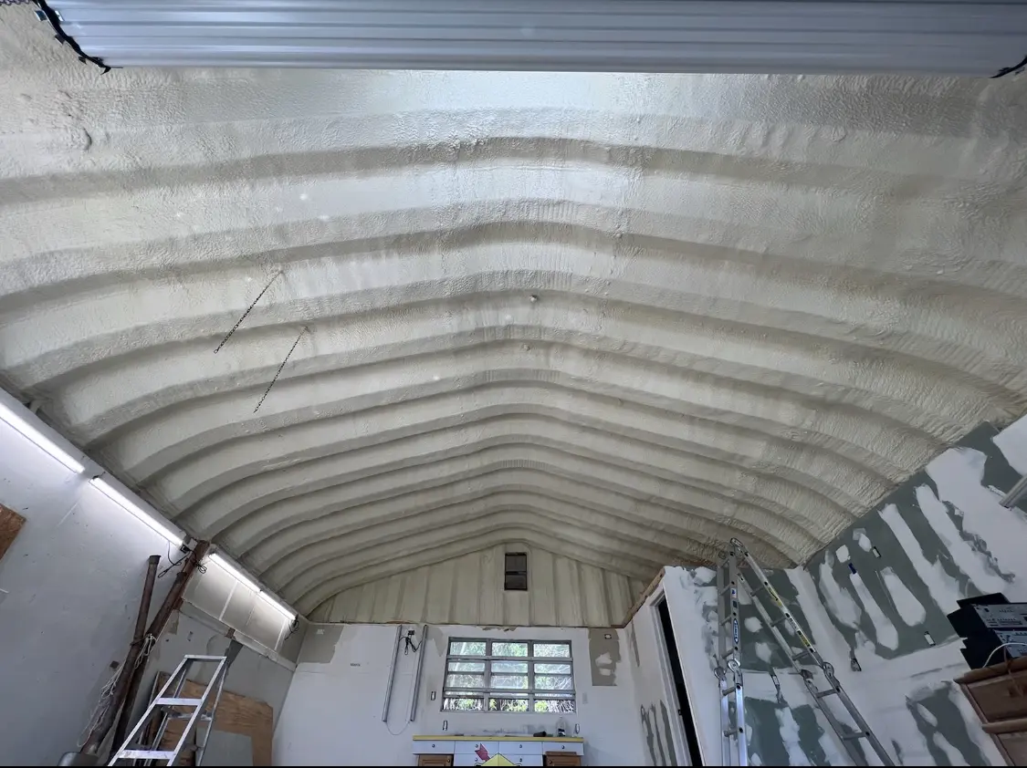 Spray polyurethane foam applied to the underside of a metal roof deck in Hermon